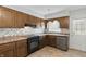 Well-lit kitchen featuring wood cabinets, stainless steel appliances, and a garden window at 3255 W 30Th St, Indianapolis, IN 46222