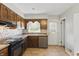 Functional kitchen featuring stainless steel appliances, wood cabinets, and a window at 3255 W 30Th St, Indianapolis, IN 46222