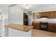 Functional kitchen with black appliances, wood cabinets and a breakfast bar at 3255 W 30Th St, Indianapolis, IN 46222