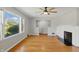 Inviting living room featuring a large window, fireplace, and a ceiling fan at 3255 W 30Th St, Indianapolis, IN 46222
