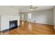 Bright living room with hardwood floors, a fireplace, and a ceiling fan at 3255 W 30Th St, Indianapolis, IN 46222