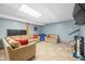 Open basement area with tile flooring, comfortable seating, and a playful atmosphere at 3331 Daniel St, Mooresville, IN 46158