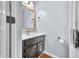 Stylish half-bathroom featuring a dark vanity, gold-framed mirror, and modern fixtures at 3331 Daniel St, Mooresville, IN 46158