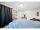 Cozy bedroom featuring a blue blanket, ample storage, and a dedicated desk area for work or study at 3331 Daniel St, Mooresville, IN 46158