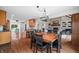 Open dining and kitchen area featuring wooden table, black chairs, granite countertops and hardwood floors at 3331 Daniel St, Mooresville, IN 46158