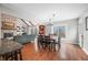 Open dining area featuring hardwood floors, natural light, and seamless transition to the living room with fireplace at 3331 Daniel St, Mooresville, IN 46158