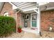 Charming front entrance with brick accents, decorative plants, and a welcoming 'HOME' sign at 3331 Daniel St, Mooresville, IN 46158