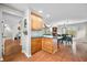 Kitchen featuring wooden cabinets, hardwood floors and open view into living and dining area at 3331 Daniel St, Mooresville, IN 46158