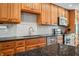 Kitchen with wooden cabinetry, granite countertops, stainless steel appliances and tile backsplash at 3331 Daniel St, Mooresville, IN 46158