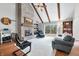 Inviting living room features a brick fireplace, vaulted ceilings, exposed beams, and sliding doors to the deck at 3331 Daniel St, Mooresville, IN 46158