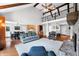 Open-concept living room with a brick fireplace, wood floors, and staircase creates a spacious and connected feel at 3331 Daniel St, Mooresville, IN 46158