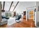 Vaulted living room featuring exposed beams, a fireplace, and sliding glass doors to a balcony at 3331 Daniel St, Mooresville, IN 46158