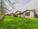 Spacious backyard with lush green lawn and mature trees at 3629 Woodglen Way, Anderson, IN 46011