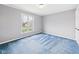 Clean bedroom with blue carpet and a window offering natural light at 3629 Woodglen Way, Anderson, IN 46011