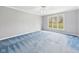Bright bedroom with blue carpet, neutral walls, and a large window offering natural light at 3629 Woodglen Way, Anderson, IN 46011