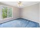 Bedroom features a ceiling fan and a window with natural light at 3629 Woodglen Way, Anderson, IN 46011