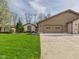 Traditional home boasts an attached garage, brick accents, and mature trees in a landscaped yard at 3629 Woodglen Way, Anderson, IN 46011