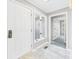 Bright foyer with marble flooring, white doors, and natural light streaming through a window at 3629 Woodglen Way, Anderson, IN 46011