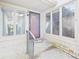 Covered porch with glass panels surrounds the front door of this cozy home at 3629 Woodglen Way, Anderson, IN 46011