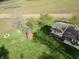 This aerial view showcases the home, shed, large yard and surrounding open fields at 3703 E Gore St, Columbus, IN 47201