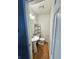 Small bathroom with pedestal sink, toilet, and wire storage shelves at 3703 E Gore St, Columbus, IN 47201