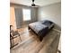 Bedroom with wood floors, a ceiling fan, and a window for natural light at 3703 E Gore St, Columbus, IN 47201