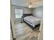 Bedroom featuring wood-look floors, ceiling fan, and a window for natural light at 3703 E Gore St, Columbus, IN 47201