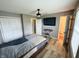 Bedroom with wood floors, a ceiling fan, and a television for entertainment at 3703 E Gore St, Columbus, IN 47201