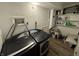 Well-lit laundry area boasts newer washer and dryer, plus built-in shelving for storage at 3703 E Gore St, Columbus, IN 47201