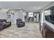 Spacious living room features comfortable seating, TV, and adjacent office space at 3703 E Gore St, Columbus, IN 47201
