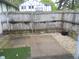 Small fenced back yard with concrete patio and loose rock at 3744 Tudor Park Dr # 2, Indianapolis, IN 46235