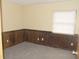 Cozy bedroom with warm-toned paneling and neutral carpet at 3744 Tudor Park Dr # 2, Indianapolis, IN 46235
