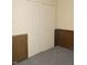 Bedroom featuring wood paneling and a large closet with paneled doors at 3744 Tudor Park Dr # 2, Indianapolis, IN 46235