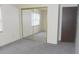 Bedroom with mirrored closet doors and a large window for natural light at 3744 Tudor Park Dr # 2, Indianapolis, IN 46235
