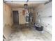 Spacious garage with shelving, heater, and water heater at 3744 Tudor Park Dr # 2, Indianapolis, IN 46235