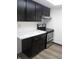 Efficient kitchen layout with black cabinets and stainless steel appliances at 3744 Tudor Park Dr # 2, Indianapolis, IN 46235