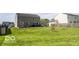 Two-story house with a large backyard featuring green grass and a wood fence at 3896 Woods Bay Ln, Plainfield, IN 46168
