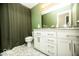Bathroom featuring a large vanity with modern fixtures, hexagon tile floors, and a shower at 3896 Woods Bay Ln, Plainfield, IN 46168