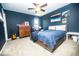 Well-lit bedroom with a modern aesthetic featuring blue walls, a ceiling fan, and carpet at 3896 Woods Bay Ln, Plainfield, IN 46168