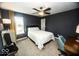 A cozy bedroom with neutral walls, carpet, and a large window for natural light at 3896 Woods Bay Ln, Plainfield, IN 46168
