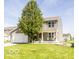 Charming two-story home with a well-manicured lawn and inviting front porch seating at 3896 Woods Bay Ln, Plainfield, IN 46168