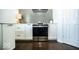 Modern kitchen featuring white cabinets, stainless steel appliances, and a stylish gray backsplash at 3896 Woods Bay Ln, Plainfield, IN 46168