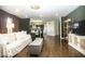 Open-concept living room with hardwood floors and neutral decor, leading into the kitchen at 3896 Woods Bay Ln, Plainfield, IN 46168