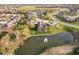 Stunning aerial view of home overlooking pond, lush trees, and a golf course in the distance at 4052 Diamond Row, Greenwood, IN 46143
