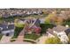 Gorgeous aerial view of home surrounded by lush greenery and a serene pond at 4052 Diamond Row, Greenwood, IN 46143
