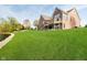 Expansive backyard with lush green lawn and brick home with walkout deck overlooking manicured lawn at 4052 Diamond Row, Greenwood, IN 46143