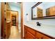Bathroom featuring wood cabinets, a marble countertop, and a doorway to a workout room at 4052 Diamond Row, Greenwood, IN 46143