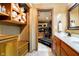 Bathroom featuring wood cabinets, a marble countertop, and a doorway to a workout room at 4052 Diamond Row, Greenwood, IN 46143