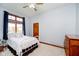 Bright bedroom with a white metal bed frame, wood window trim, and light blue walls at 4052 Diamond Row, Greenwood, IN 46143