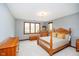 Bedroom featuring a four-poster bed, wood trim, and natural light at 4052 Diamond Row, Greenwood, IN 46143